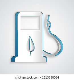 Paper cut Bio fuel concept with fueling nozzle and leaf icon isolated on grey background. Gas station with leaves. Eco refueling. Paper art style. Vector Illustration