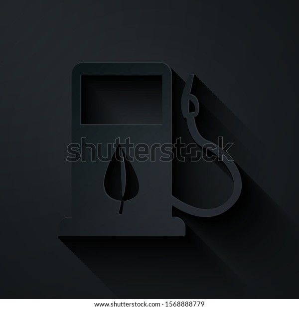 Paper cut Bio fuel concept\
with fueling nozzle and leaf icon isolated on black background. Gas\
station with leaves. Eco refueling. Paper art style. Vector\
Illustration