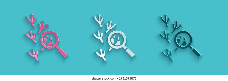 Paper cut Bird footprint under magnifying glass icon isolated on blue background. Animal foot. Paper art style. Vector