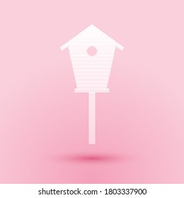 Paper cut Bird house icon isolated on pink background. Nesting box birdhouse, homemade building for birds. Paper art style. Vector.