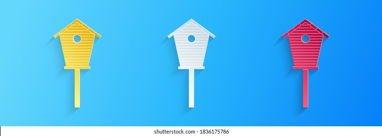 Paper cut Bird house icon isolated on blue background. Nesting box birdhouse, homemade building for birds. Paper art style. Vector.