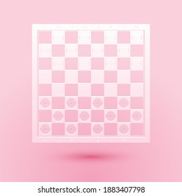 Paper cut Board game of checkers icon isolated on pink background. Ancient Intellectual board game. Chess board. White and black chips. Paper art style. Vector.