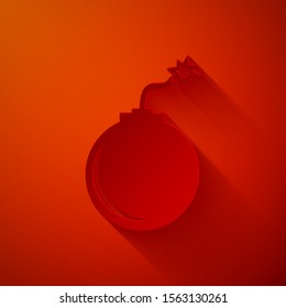 Paper cut Bomb ready to explode icon isolated on red background. Paper art style. Vector Illustration