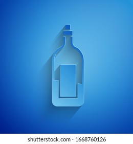 Paper cut Bottle of wine icon isolated on blue background. Paper art style. Vector Illustration