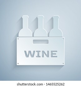 Paper cut Bottles of wine in a wooden box icon isolated on grey background. Wine bottles in a wooden crate icon. Paper art style. Vector Illustration