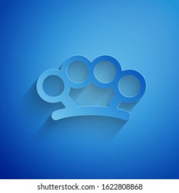 Paper cut Brass knuckles icon isolated on blue background. Paper art style. Vector Illustration