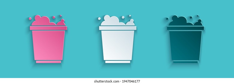 Paper cut Bucket with foam and bubbles icon isolated on blue background. Cleaning service concept. Paper art style. Vector