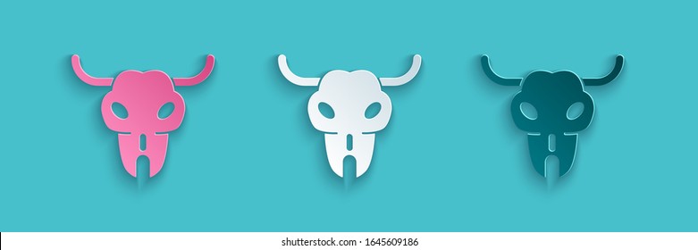 Paper cut Buffalo skull icon isolated on blue background. Paper art style. Vector Illustration