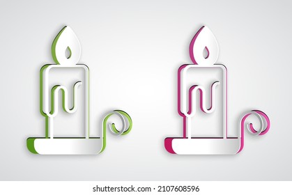 Paper cut Burning candle in candlestick icon isolated on grey background. Cylindrical candle stick with burning flame. Paper art style. Vector