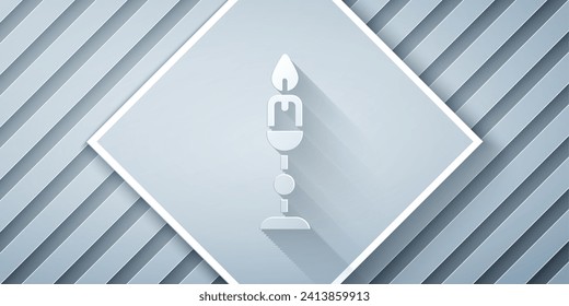 Paper cut Burning candle in candlestick icon isolated on grey background. Old fashioned lit candle. Cylindrical candle stick with burning flame. Paper art style. Vector