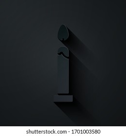 Paper cut Burning candle icon isolated on black background. Cylindrical candle stick with burning flame. Paper art style. Vector Illustration