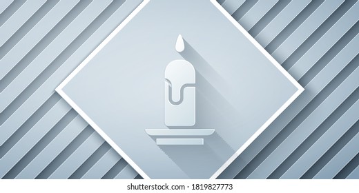 Paper cut Burning candle icon isolated on grey background. Cylindrical candle stick with burning flame. Paper art style. Vector Illustration