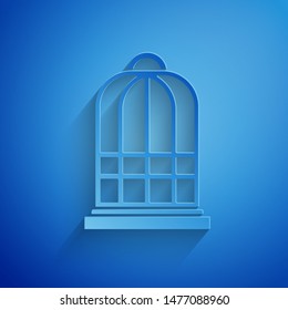 Paper cut Cage for birds icon isolated on blue background. Paper art style. Vector Illustration