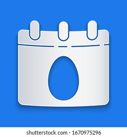 Paper cut Calendar with Easter egg icon isolated on blue background. Spring Christian Holiday symbol. Paper art style. Vector Illustration