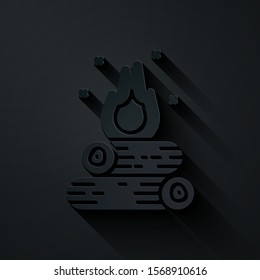 Paper cut Campfire icon isolated on black background. Burning bonfire with wood. Paper art style. Vector Illustration