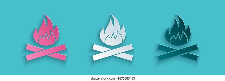 Paper cut Campfire icon isolated on blue background. Burning bonfire with wood. Paper art style. Vector Illustration