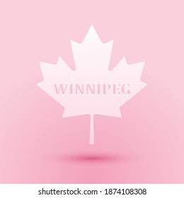 Paper cut Canadian maple leaf with city name Winnipeg icon isolated on pink background. Paper art style. Vector.