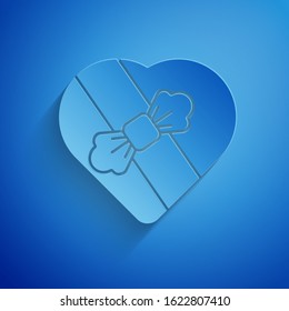 Paper cut Candy in heart shaped box and bow icon isolated on blue background. Valentines Day. Paper art style. Vector Illustration