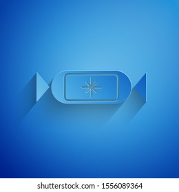 Paper cut Candy icon isolated on blue background. Merry Christmas and Happy New Year. Paper art style. Vector Illustration