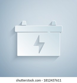 Paper cut Car battery icon isolated on grey background. Accumulator battery energy power and electricity accumulator battery. Paper art style. Vector.