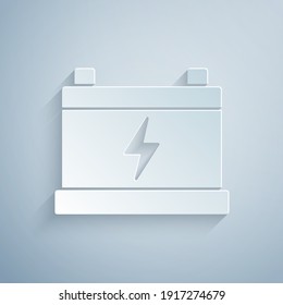 Paper cut Car battery icon isolated on grey background. Accumulator battery energy power and electricity accumulator battery. Paper art style. Vector.