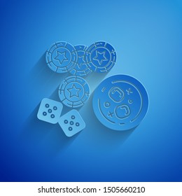 Paper cut Casino chips, game dice and glass of whiskey with ice cubes icon isolated on blue background. Casino poker. Paper art style. Vector Illustration
