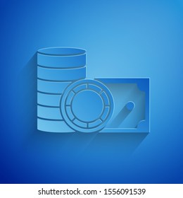 Paper cut Casino chips and stacks paper money cash icon isolated on blue background. Casino gambling. Paper art style. Vector Illustration