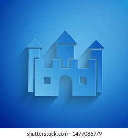 Paper cut Castle icon isolated on blue background. Paper art style. Vector Illustration