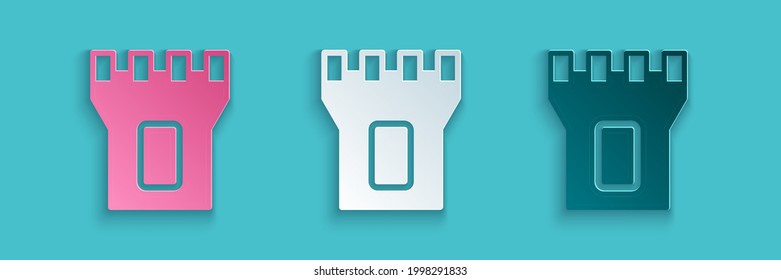 Paper cut Castle tower icon isolated on blue background. Fortress sign. Paper art style. Vector