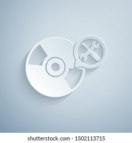 Paper cut CD or DVD disk with screwdriver and wrench icon isolated on grey background. Adjusting, service, setting, maintenance, repair, fixing. Paper art style. Vector Illustration