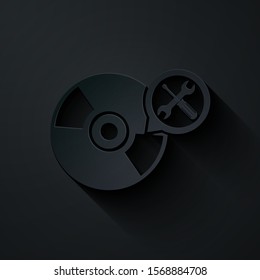 Paper cut CD or DVD disk with screwdriver and wrench icon isolated on black background. Adjusting, service, setting, maintenance, repair, fixing. Paper art style. Vector Illustration