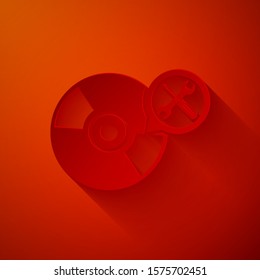 Paper cut CD or DVD disk with screwdriver and wrench icon isolated on red background. Adjusting, service, setting, maintenance, repair, fixing. Paper art style. Vector Illustration