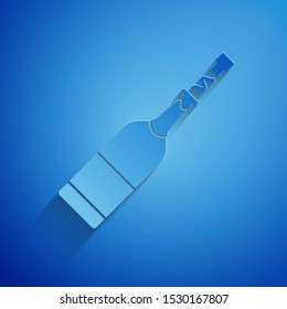 Paper cut Champagne bottle icon isolated on blue background. Paper art style. Vector Illustration