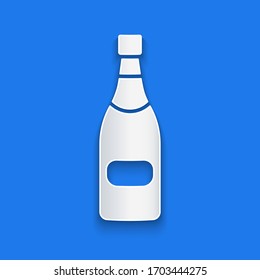 Paper cut Champagne bottle icon isolated on blue background. Paper art style. Vector Illustration