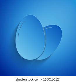 Paper cut Chicken egg icon isolated on blue background. Paper art style. Vector Illustration