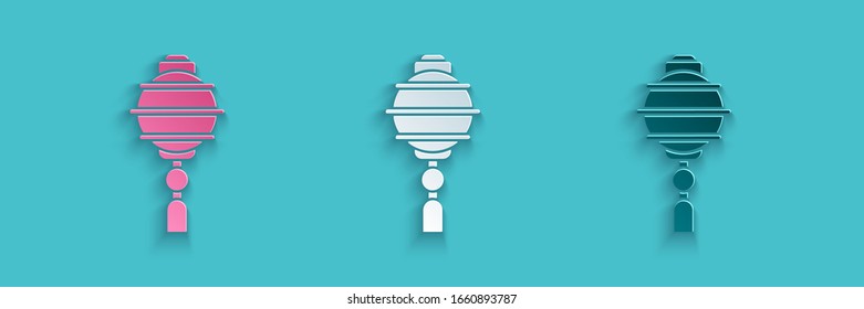 Paper cut Chinese paper lantern icon isolated on blue background. Paper art style. Vector Illustration