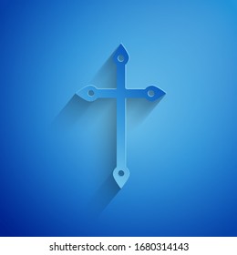 Paper cut Christian cross icon isolated on blue background. Church cross. Paper art style. Vector Illustration