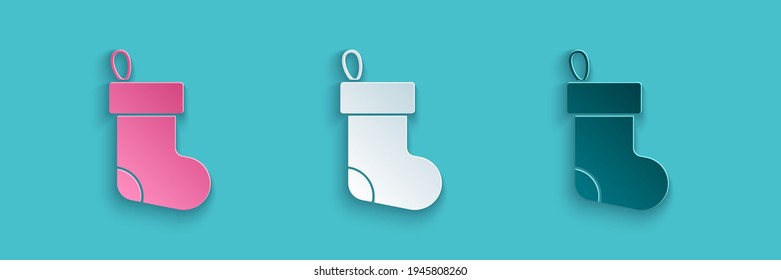 Paper cut Christmas stocking icon isolated on blue background. Merry Christmas and Happy New Year. Paper art style. Vector