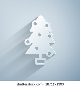 Paper cut Christmas tree with decorations icon isolated on grey background. Merry Christmas and Happy New Year. Paper art style. Vector