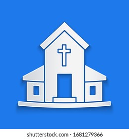 Paper cut Church building icon isolated on blue background. Christian Church. Religion of church. Paper art style. Vector Illustration