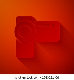 Paper cut Cinema camera icon isolated on red background. Video camera. Movie sign. Film projector. Paper art style. Vector Illustration