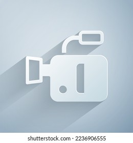 Paper cut Cinema camera icon isolated on grey background. Video camera. Movie sign. Film projector. Paper art style. Vector