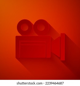 Paper cut Cinema camera icon isolated on red background. Video camera. Movie sign. Film projector. Paper art style. Vector
