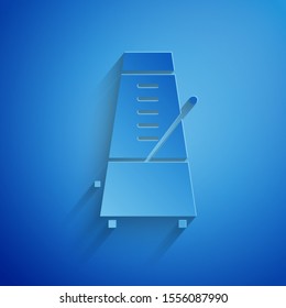 Paper cut Classic Metronome with pendulum in motion icon isolated on blue background. Equipment of music and beat mechanism. Paper art style. Vector Illustration