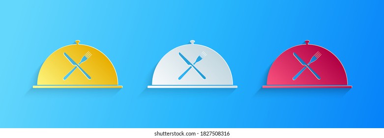 Paper cut Cloche with crossed fork and knife icon isolated on blue background. Restaurant symbol. Paper art style. Vector.