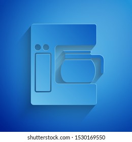 Paper cut Coffee machine with glass pot icon isolated on blue background. Paper art style. Vector Illustration