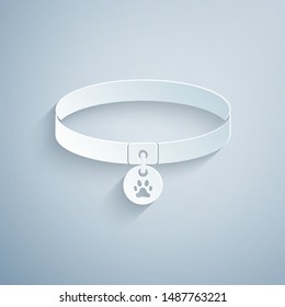 Paper cut Collar with name tag icon isolated on grey background. Supplies for domestic animal. Dog or cat paw print. Cat and dog care. Pet chains. Paper art style. Vector Illustration Paper cut Collar with name tag icon isolated on grey background. Supplies for domestic animal. Dog or cat paw print. Cat and dog care. Pet chains. Paper art style. Vector Illustration