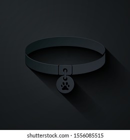 Paper cut Collar with name tag icon isolated on black background. Supplies for domestic animal. Dog or cat paw print. Cat and dog care. Pet chains. Paper art style. Vector Illustration