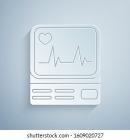 Paper cut Computer monitor with cardiogram icon isolated on grey background. Monitoring icon. ECG monitor with heart beat hand drawn. Paper art style. Vector Illustration