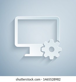 Paper cut Computer monitor and gear icon isolated on grey background. Adjusting, service, setting, maintenance, repair, fixing. Paper art style. Vector Illustration